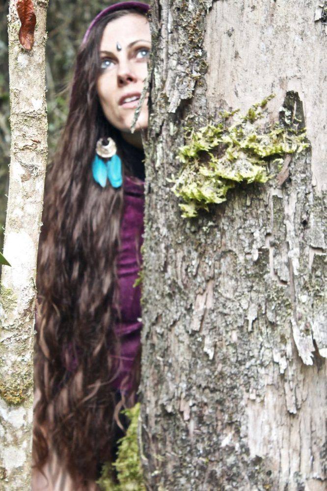 Michela peeking from behind a tree — Elf Path